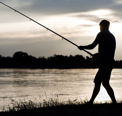 man fishing at sunset