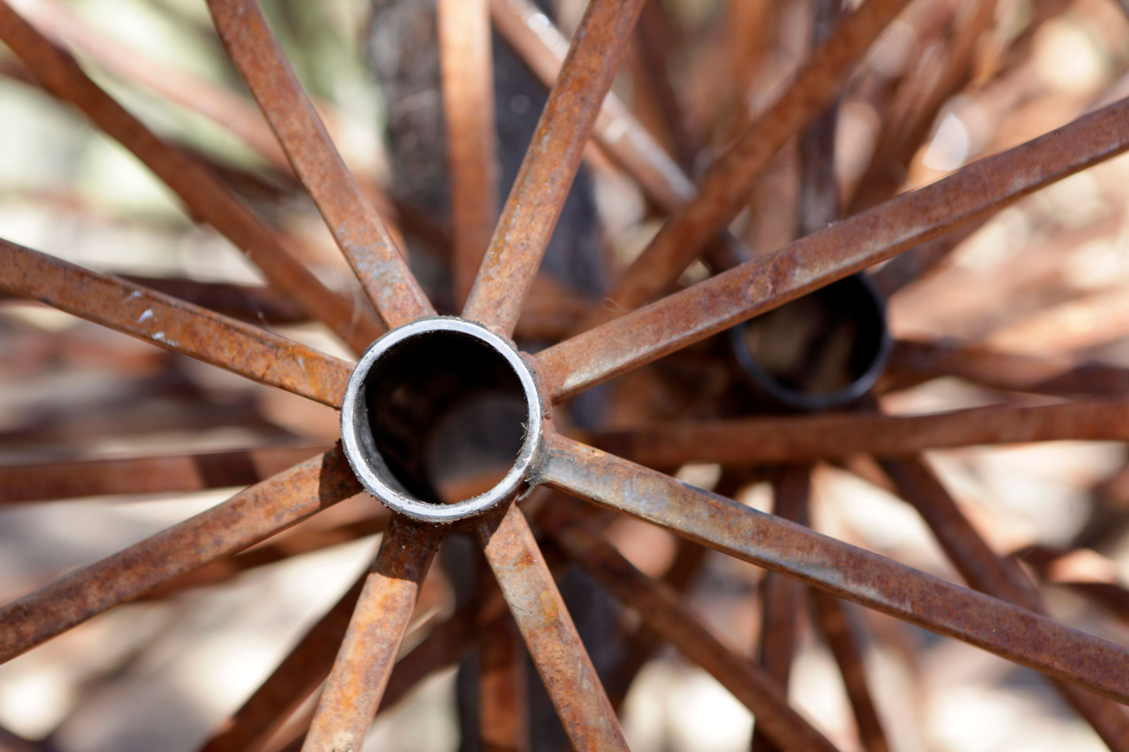 A picture of wagon wheel spokes, with more in the background.
