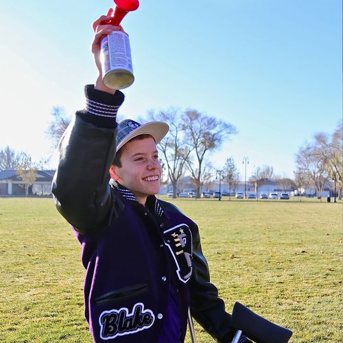 young man blowing air horn