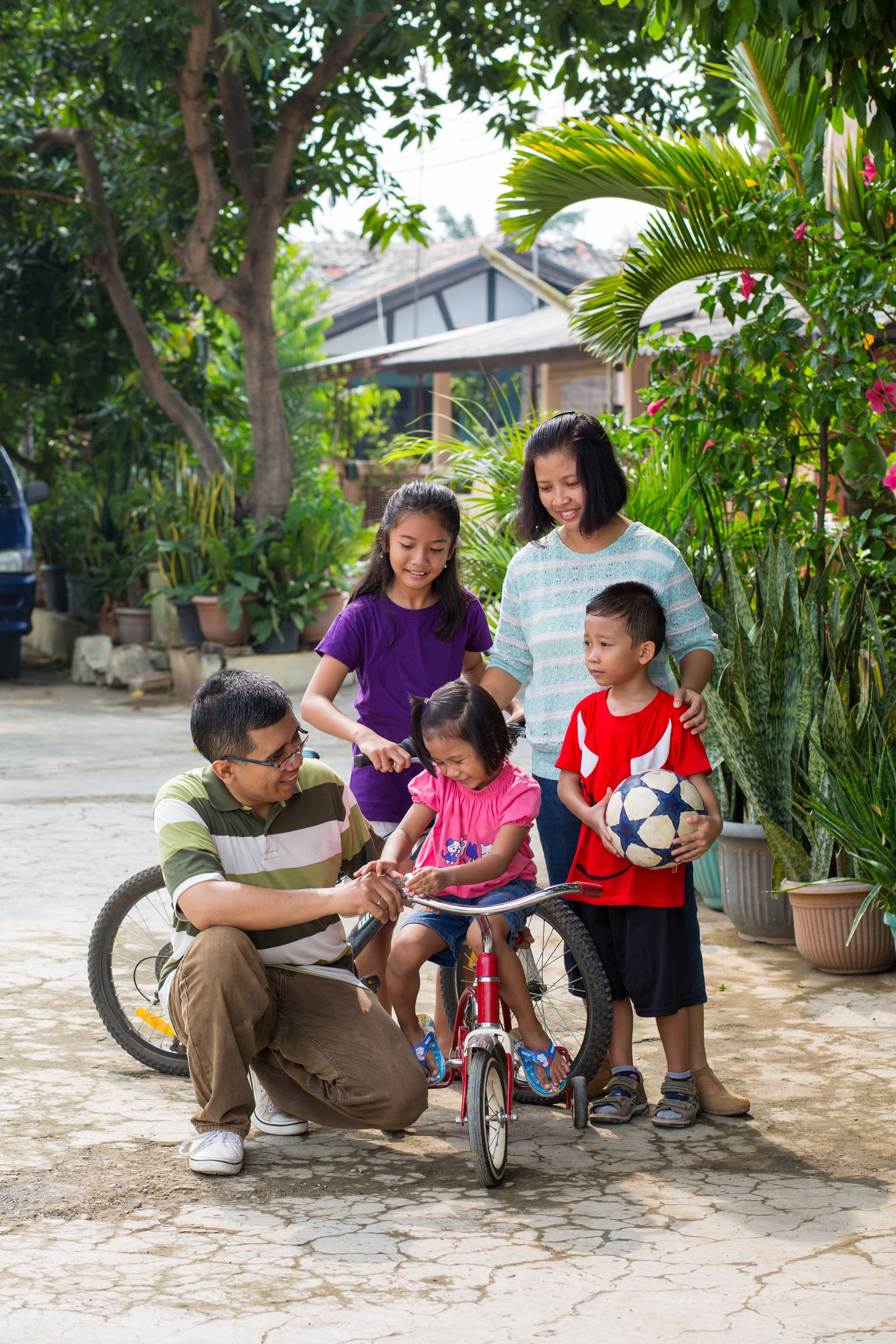 A family preparing to ride bikes together.