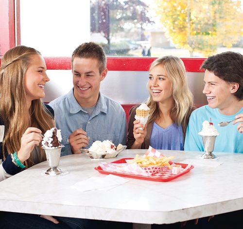 young people eating ice cream at restaurant