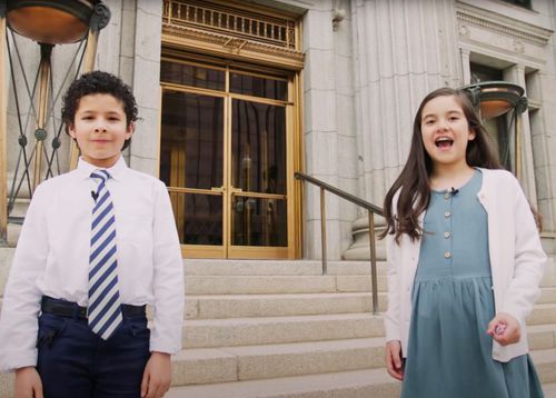 boy and girl standing outside a Church building