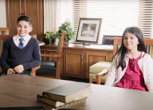 boy and girl sitting in office