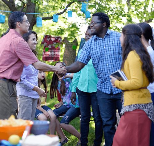 two men shaking hands at a party