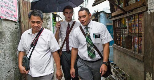 missionaries walking in the rain