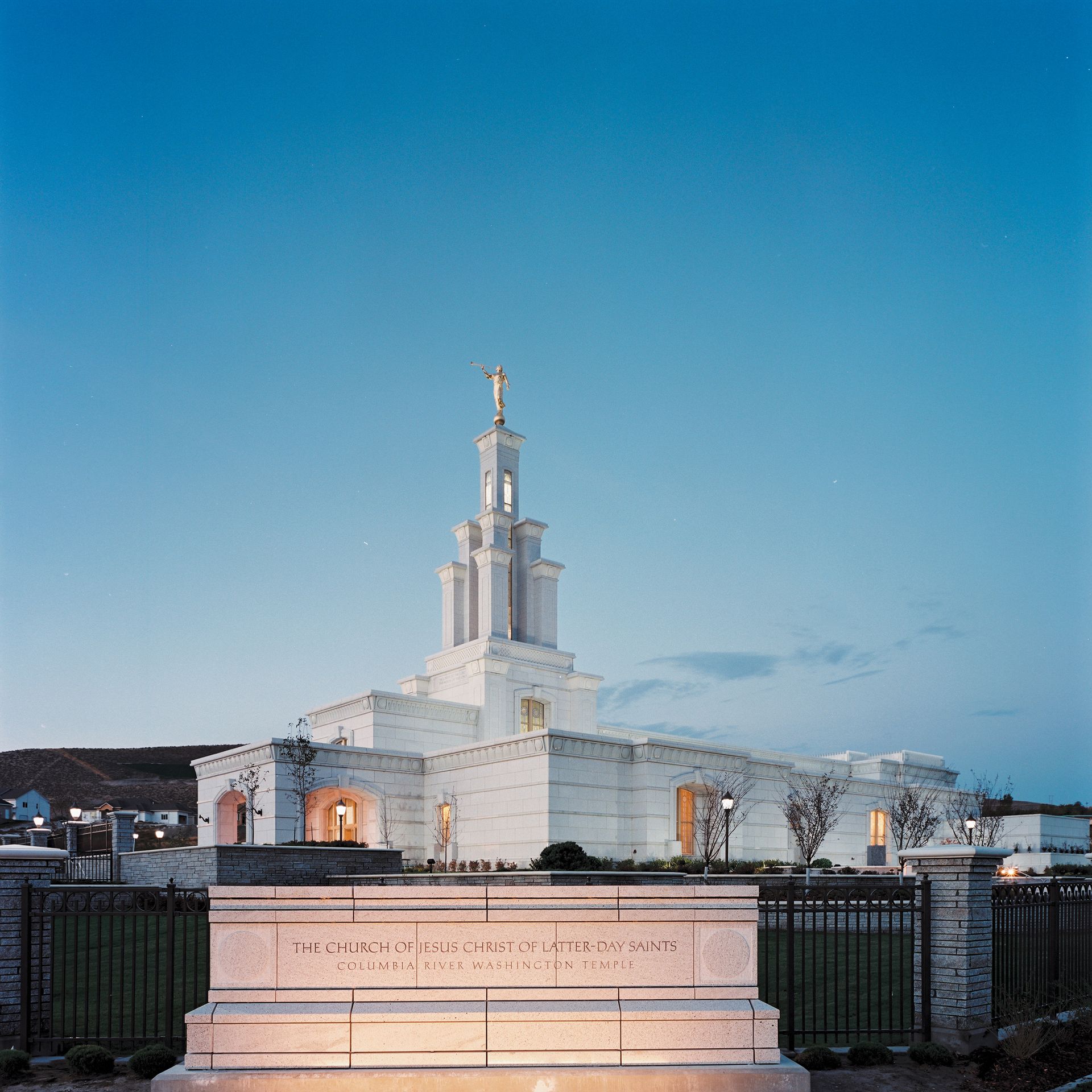 An evening view of the temple name sign in front of the Columbia River Washington Temple.