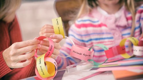 mother and daughter making a paper chain