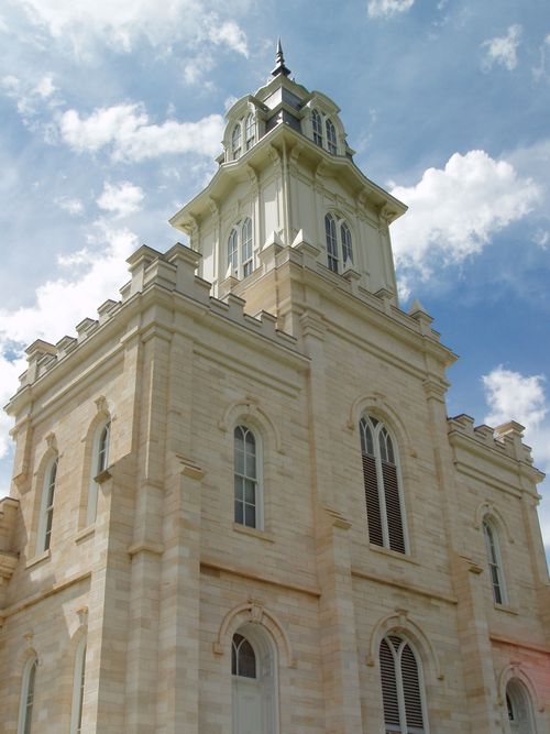 A close-up of one of the Manti Utah Temple spires, with a blue sky and clouds in the distance.