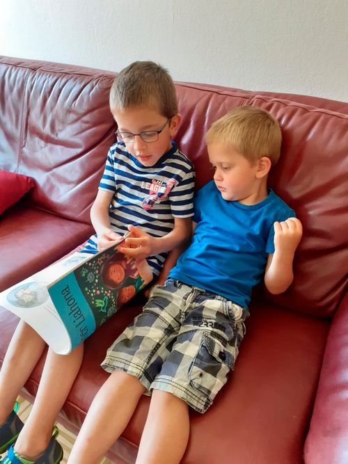 two boys reading Friend magazine