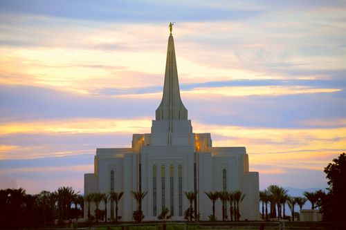 The back of the Gilbert Arizona Temple, just after sunset as the temple’s lights are coming on to illuminate the spire.