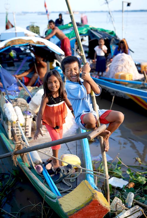 boy and girl on a colorful boat