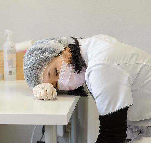 una mujer descansando sobre el escritorio