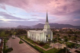 Photograph of the Rio De Janeiro Brazil Temple. The image features the exterior of the temple, including the temple grounds during the sunset.