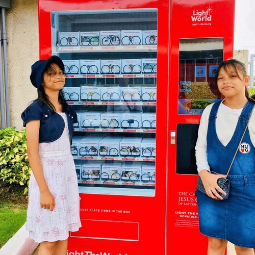 two young women at Light the World giving maching