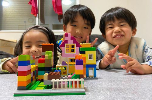 siblings showing their block buildings