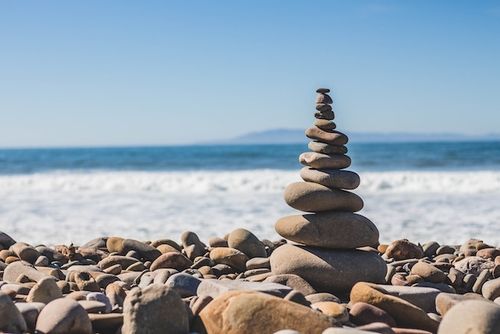 tower of pebbles by ocean