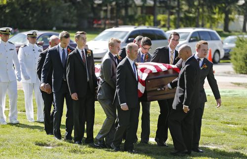 grandsons carrying casket