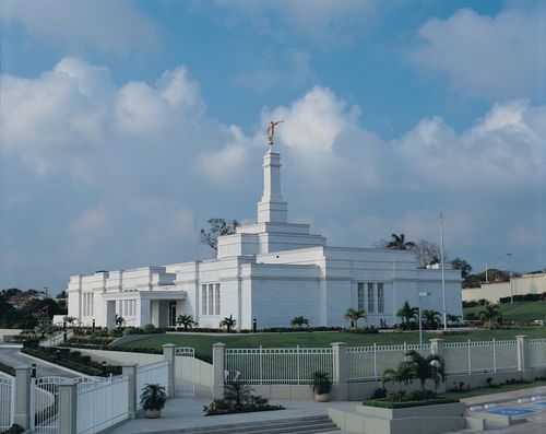The entire view of the Tampico Mexico Temple, including the grounds, fence, palm trees, and bushes.