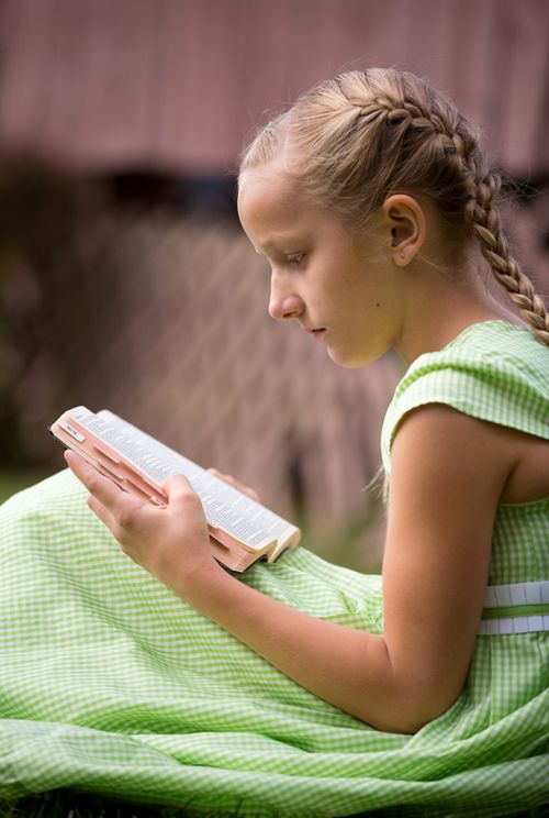 Child reading the Book of Mormon