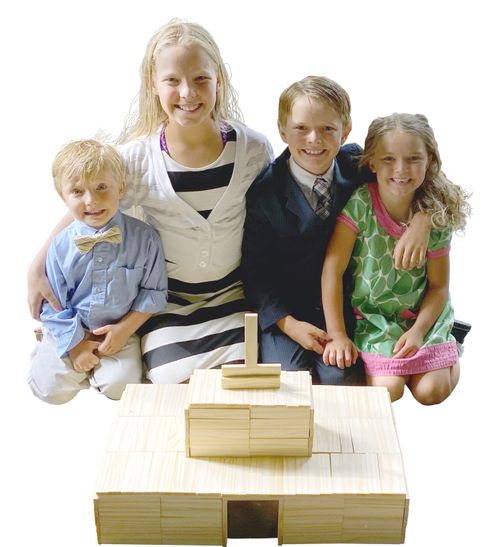 The Ulrich family in front of a temple made of popsicle sticks.