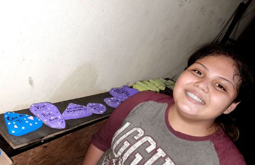 young woman with painted rocks