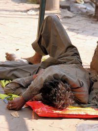 man laying on street