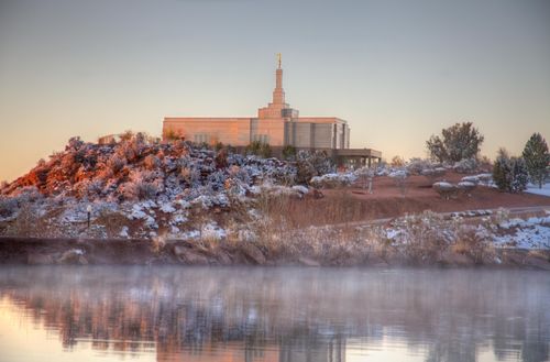 A view of the entire Snowflake Arizona Temple from across a lake. The grounds around the temple are covered in snow.