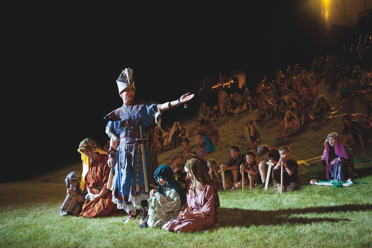A Nephite standing in the foreground and Nephite children in the background at the Manti Pageant.