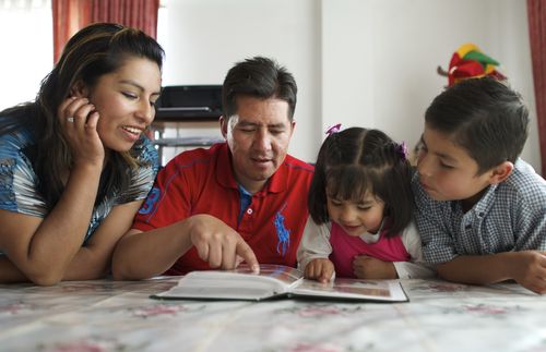 family looking at a book