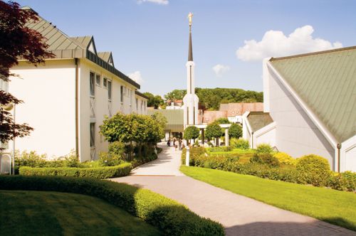 A back view of the Frankfurt Germany Temple on a sunny day, with another building seen on the left.