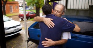 a father and son hug