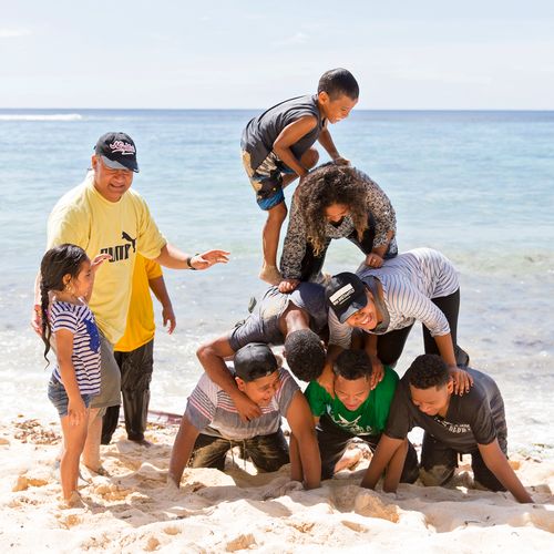 family playing at beach