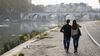 couple walking by river