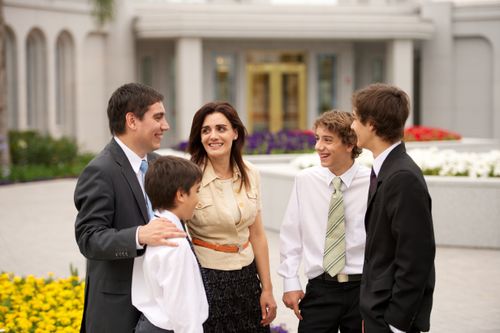 A mother, father, and three sons dressed in their church clothes, standing outside the Buenos Aires Argentina Temple.