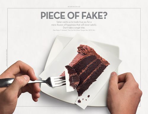 A fork holds a piece of chocolate cake that is actually only paper rather than real cake.