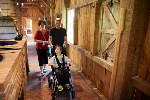 parents with young boy in wheelchair