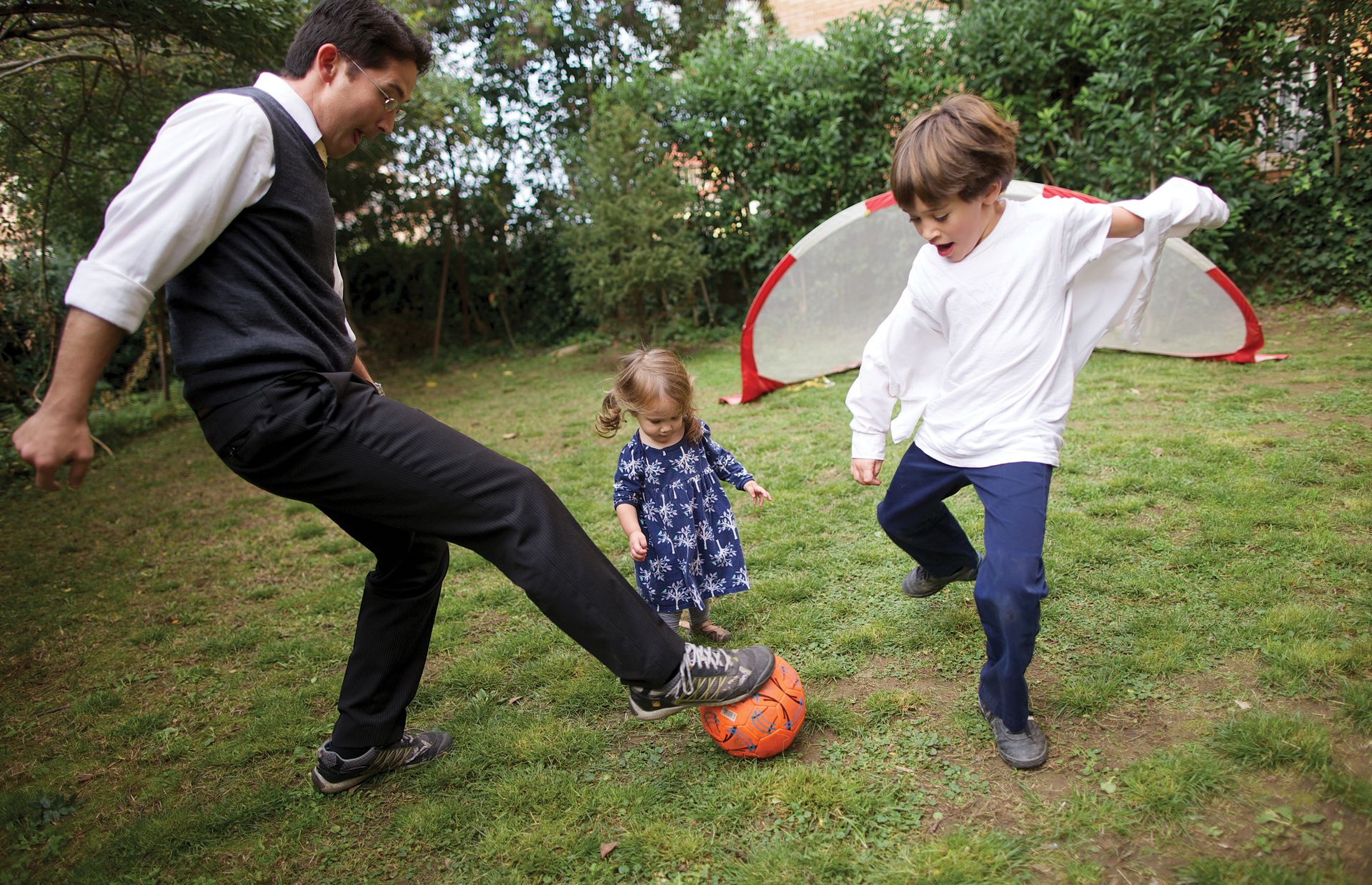Niki plays soccer with his children.