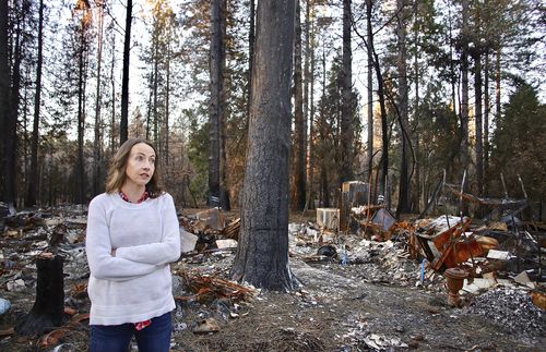 Rachel standing near burned down home