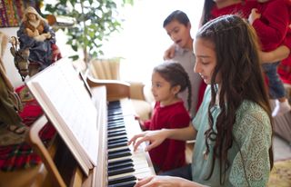 family gathered around piano