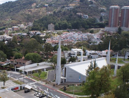 A view from afar of the Guatemala City Guatemala Temple, with the surrounding neighborhoods, buildings, and streets in the frame.