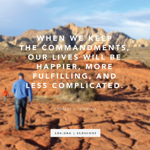 A photograph of a man and a young boy hiking on red rocks, with a quote from President Thomas S. Monson: “Keep the commandments.”