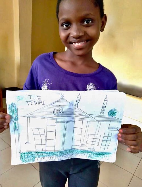 girl holding drawing of temple