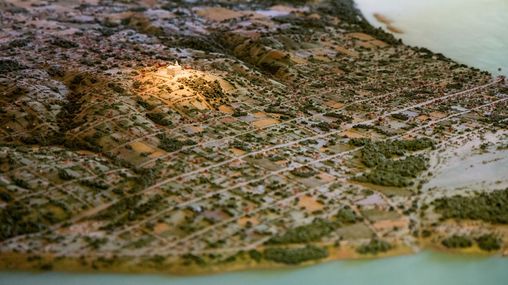 A model scale of Nauvoo with a light illuminating the Nauvoo Temple. 