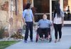 Man in wheelchair with others coming out of church