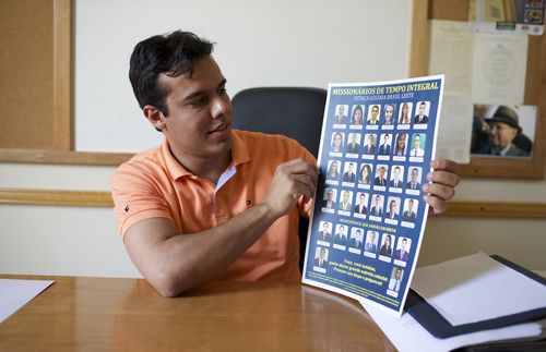 Young family in Brazil read together, parents teach children with drawings, they sing together, mother reading, father holding up chart etc.