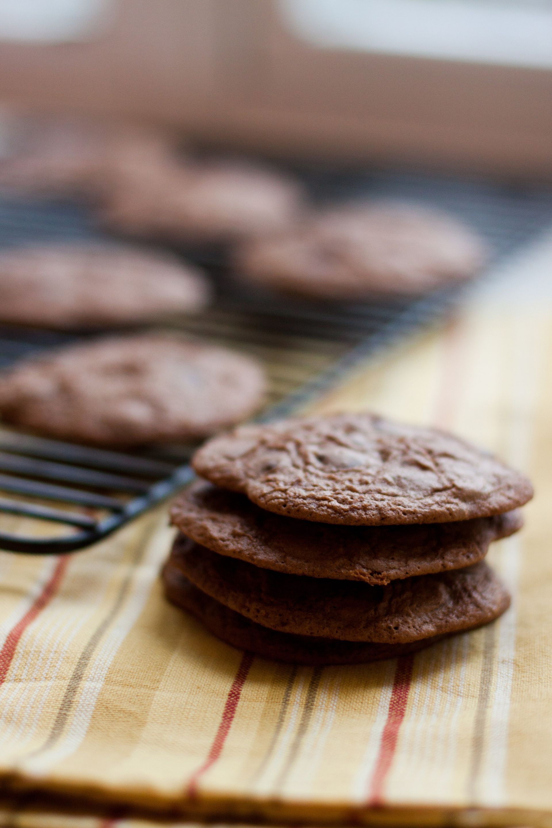 Chocolate cookies on a cooling rack.