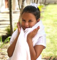 girl holding up white blanket