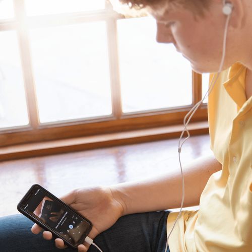young man listening to podcast