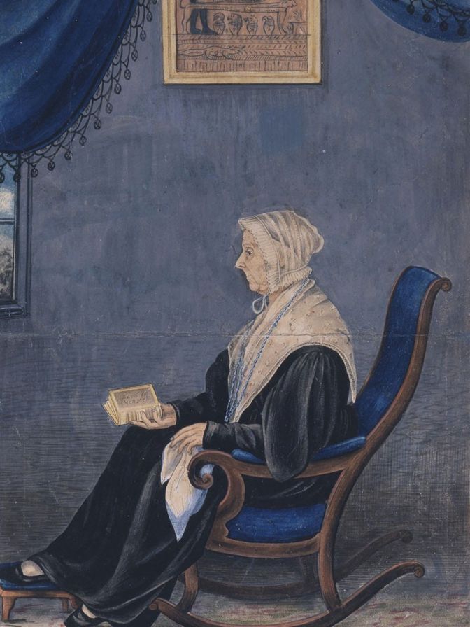 Painting of an elderly woman seated in a rocking chair. She is holding a book in her hand.