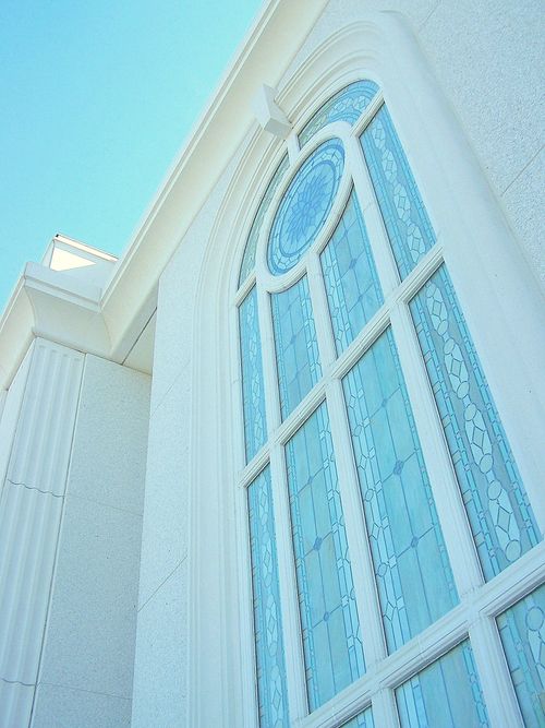 A detail of a stained-glass window on the Orlando Florida Temple reflecting the blue light of the sky.